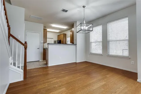 a view of a room with window wooden floor and chandelier