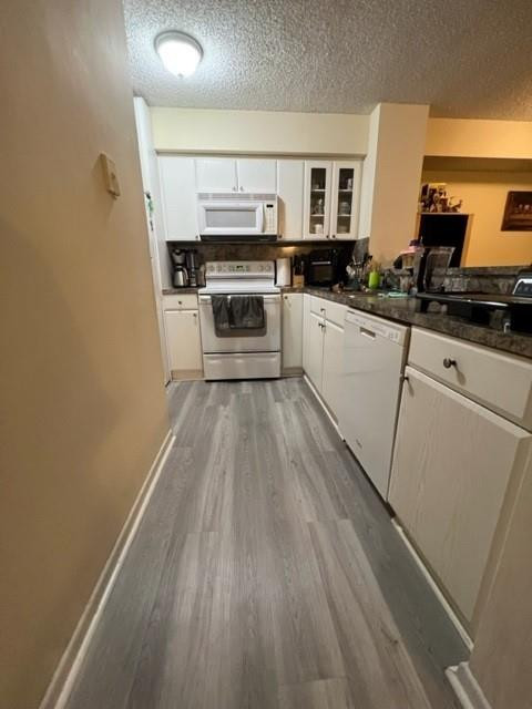560 South Park Road, Unit 147 Hollywood, FL 33021 - Photo 13 of 16 a kitchen with wooden cabinets and a stove top oven