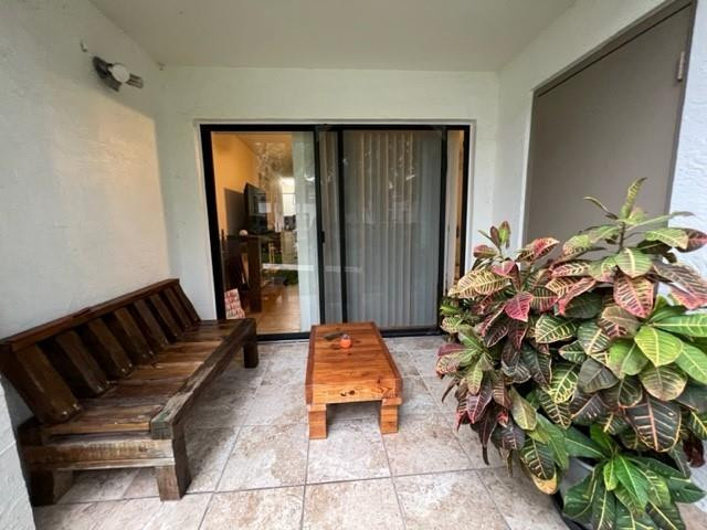 560 South Park Road, Unit 147 Hollywood, FL 33021 - Photo 16 of 16 a hallway with a couch and a potted plant
