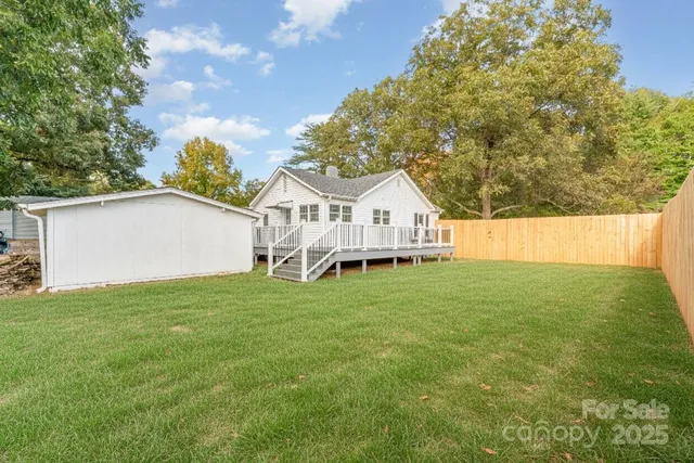 a view of white house with a yard