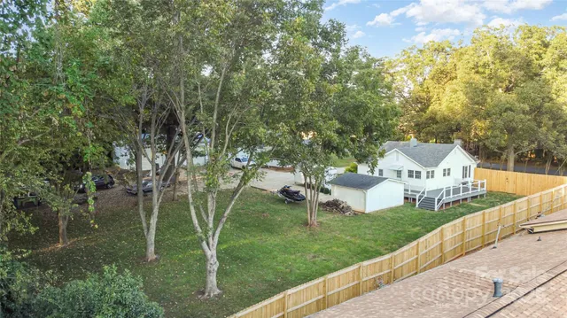 a view of a house with a yard and sitting area