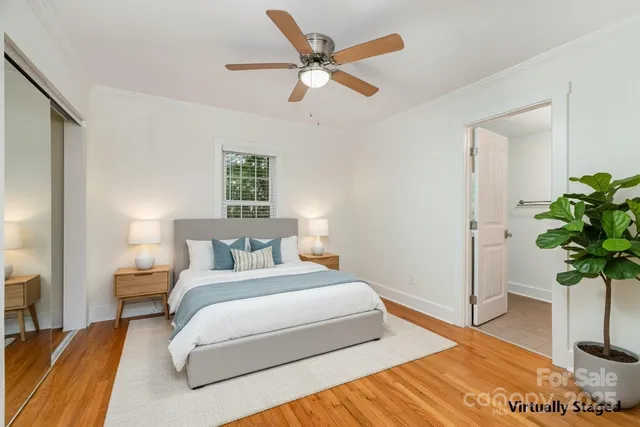 a bedroom with bed and a potted plant