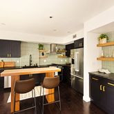 a kitchen with stainless steel appliances a stove a sink refrigerator and cabinets