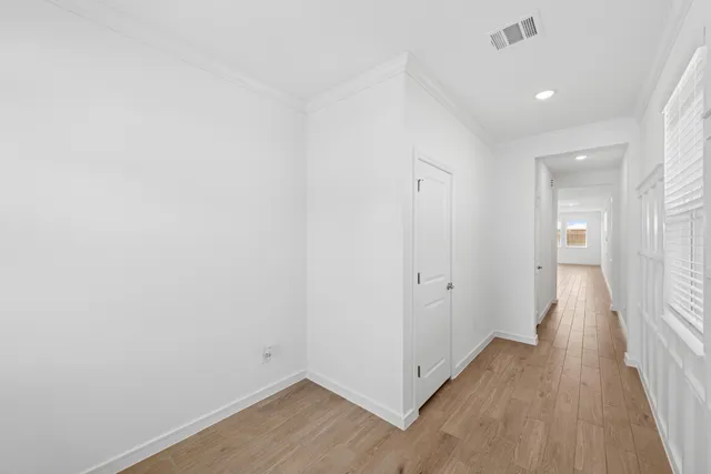 a view of a hallway with wooden floor