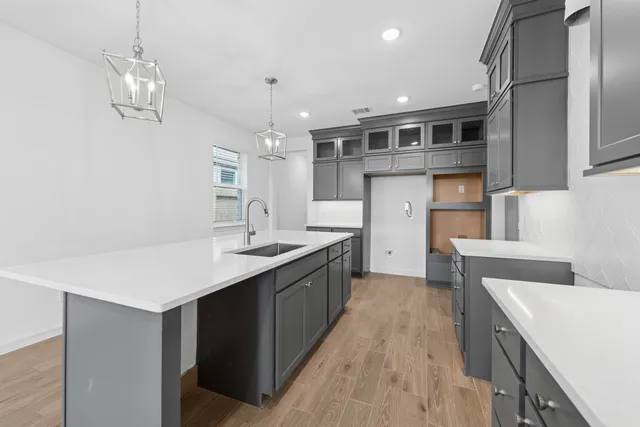 a kitchen with stainless steel appliances granite countertop a sink a stove and a refrigerator