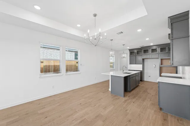 a large kitchen with a large counter top appliances and cabinets