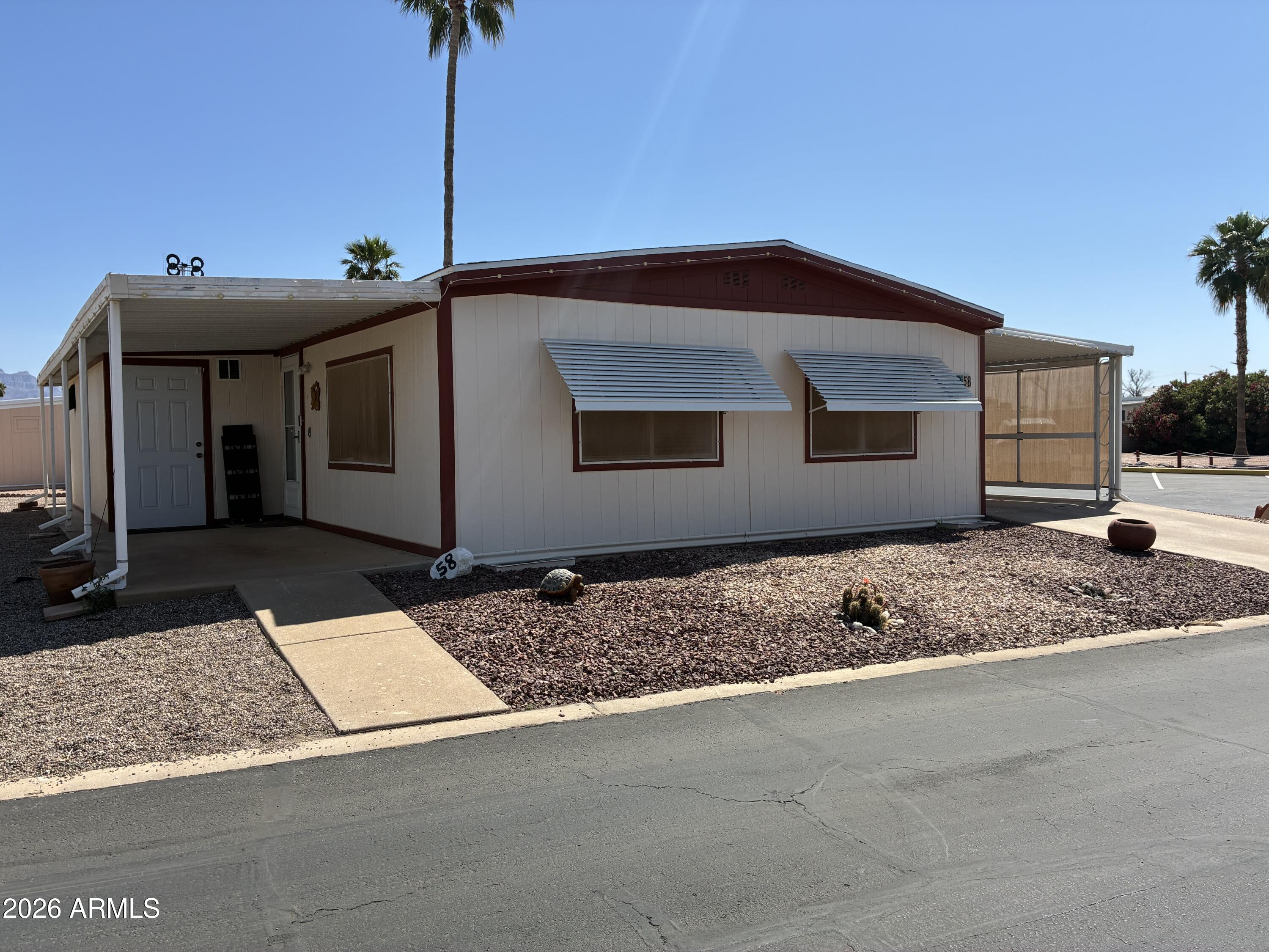 53 North Mountain Road, Unit 58 Apache Junction, AZ 85120 - Photo 33 of 39 a front view of a house with a yard