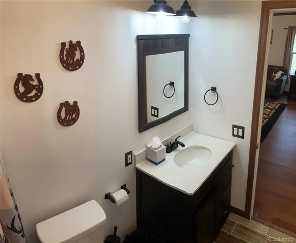 a bathroom with a sink mirror and toilet