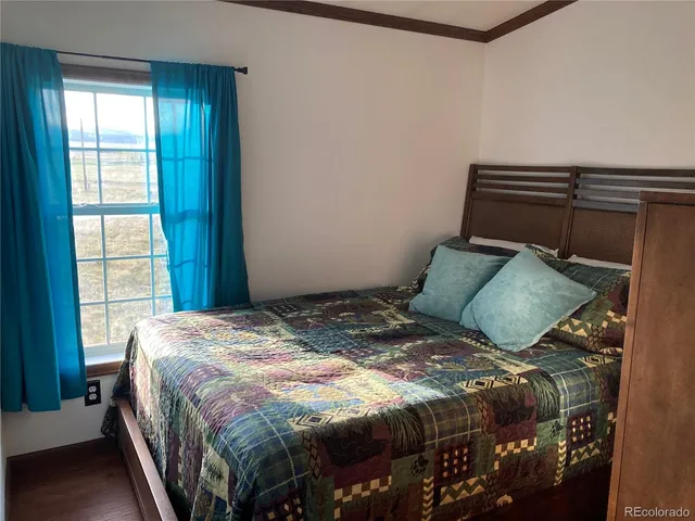 a bedroom with a bed and window