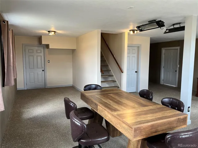 a room with a table chairs and entryway
