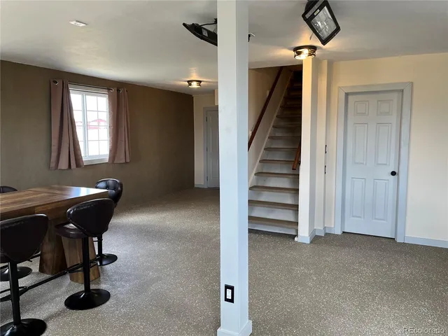 a view of a livingroom with entryway and workspace