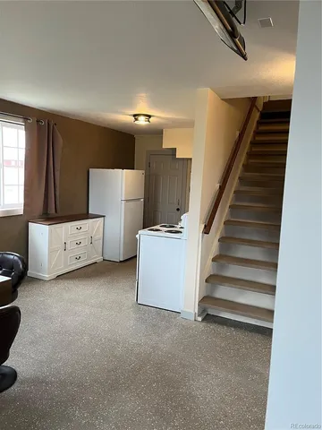 a view of an empty room with stairs and stairs