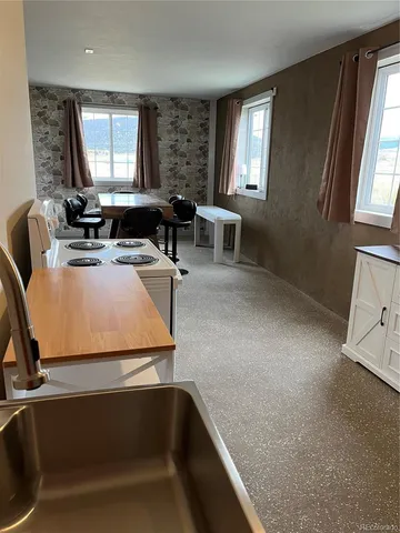 a kitchen with a sink a counter top space and a window