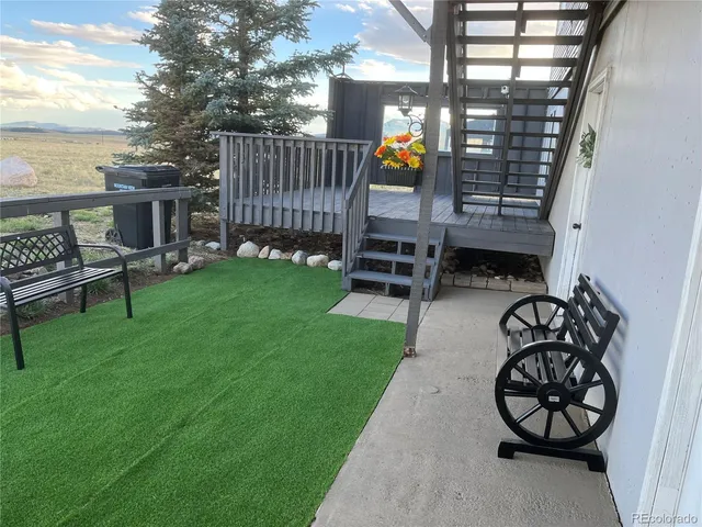 a view of a chairs and table in the back yard
