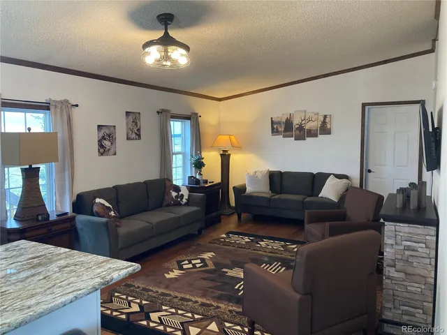 a living room with furniture and a chandelier