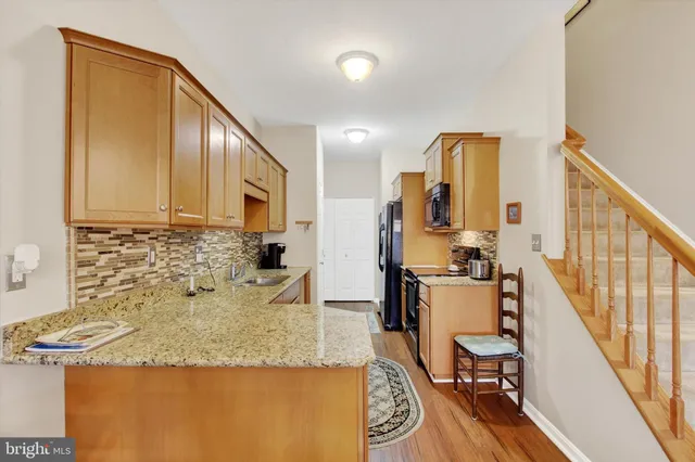 a kitchen with sink refrigerator and stove