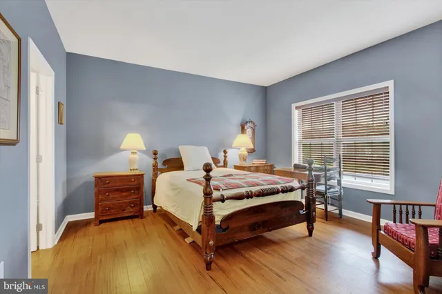 a bed room with a bed and a chair