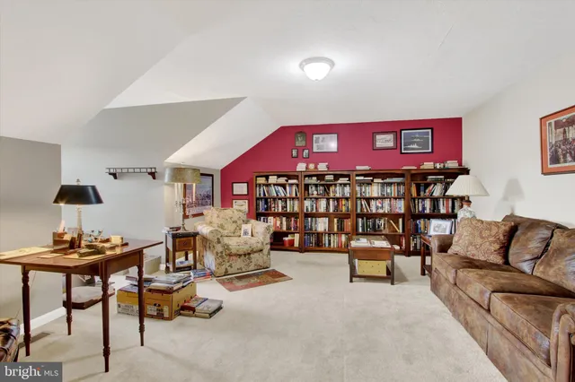 a reading room with furniture and a lamp