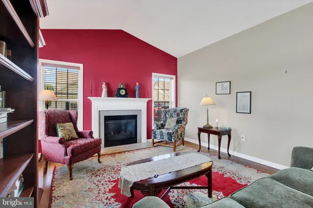 a living room with furniture a dining table and a fireplace