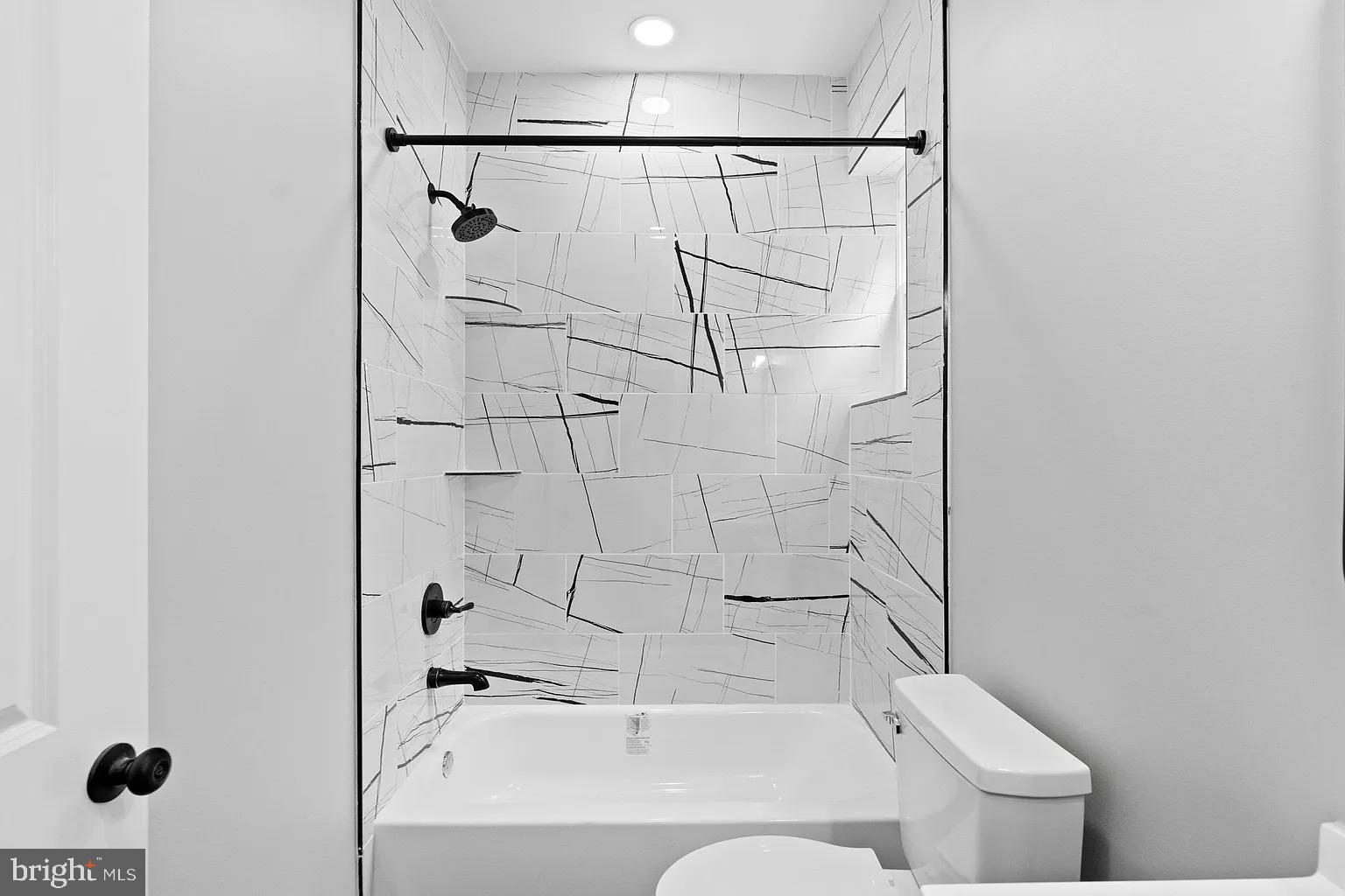 6232 Reedland Street, Unit 1 Philadelphia, PA 19142 - Photo 4 of 8 a bathroom with a sink a toilet and shower