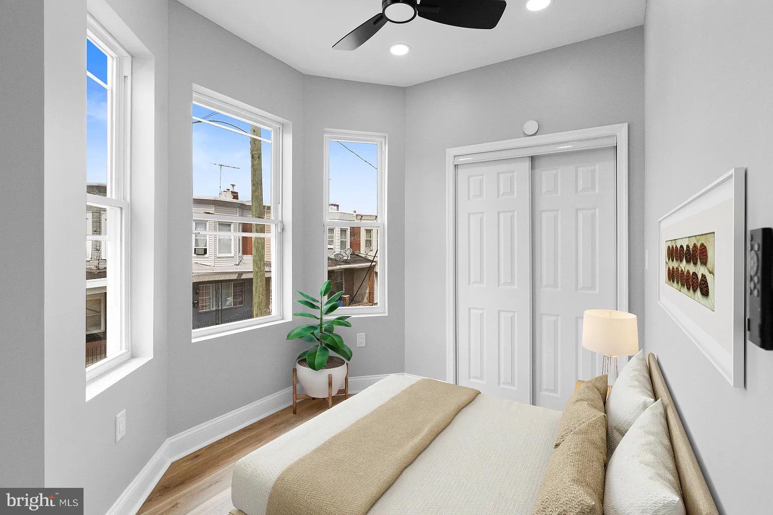 6232 Reedland Street, Unit 1 Philadelphia, PA 19142 - Photo 5 of 8 a bedroom with a bed and a potted plant on the dresser