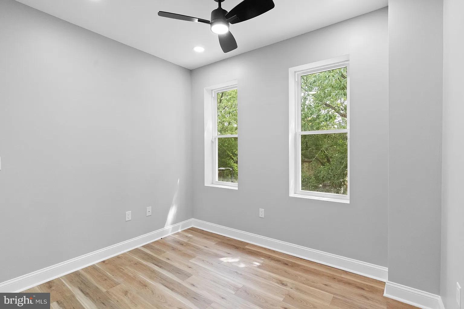 6232 Reedland Street, Unit 1 Philadelphia, PA 19142 - Photo 7 of 8 an empty room with a window and ceiling fan