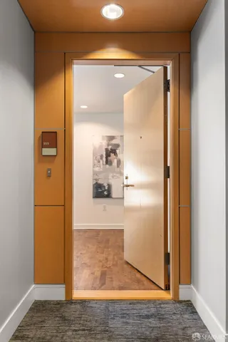 a view of a hallway with wooden floor