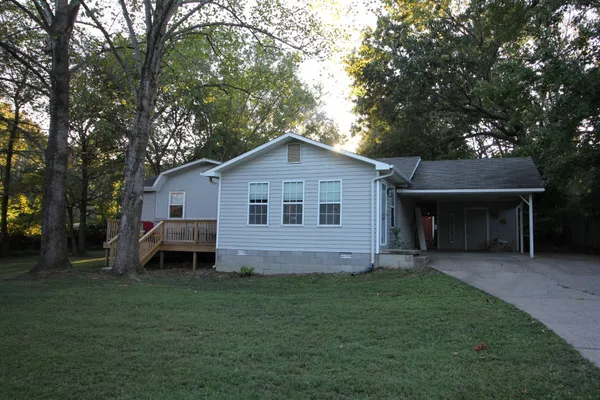 a front view of house with yard and green space