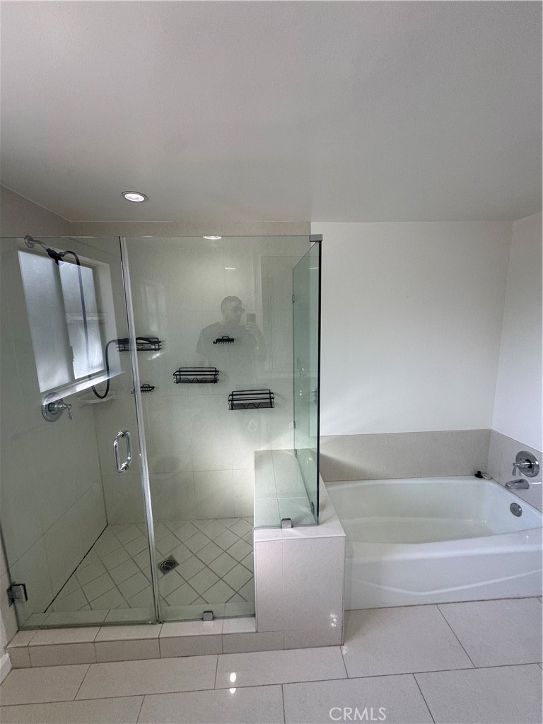 11445 Etiwanda Avenue Porter Ranch, CA 91326 - Photo 16 of 28 a bathroom with a bathtub and a shower