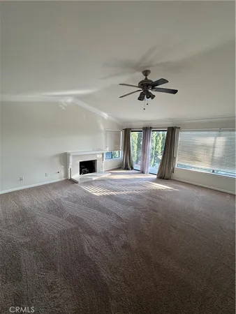 a living room with furniture and a ceiling fan