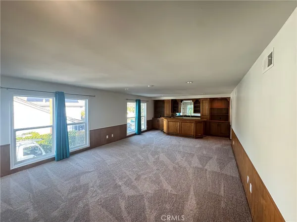 a view of empty room with a fireplace and window