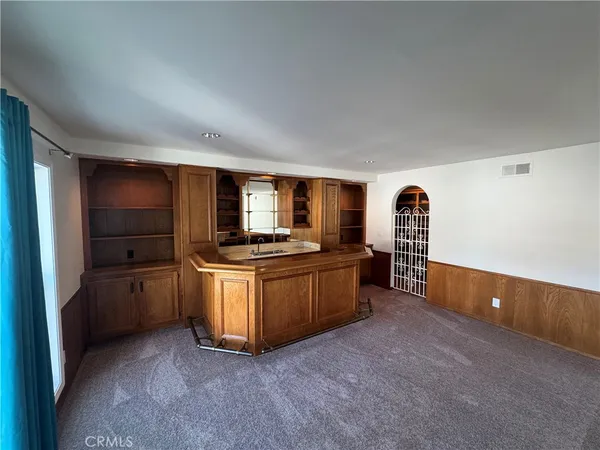 a kitchen with stainless steel appliances kitchen island granite countertop a refrigerator oven a sink and dishwasher