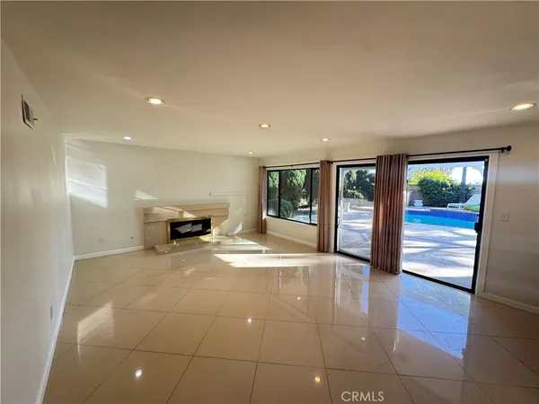 a view of an empty room with glass door