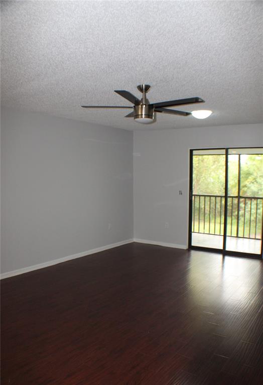 1194 Falcon Drive, Unit 14 Dunedin, FL 34698 - Photo 12 of 20 a view of an empty room with a window and wooden floor