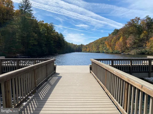 a view of balcony with wooden floor and fence