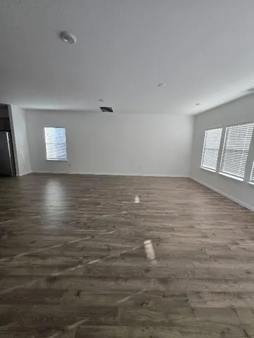 a living room with furniture or couch and a wooden floor