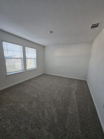 a living room with furniture potted plant and a table