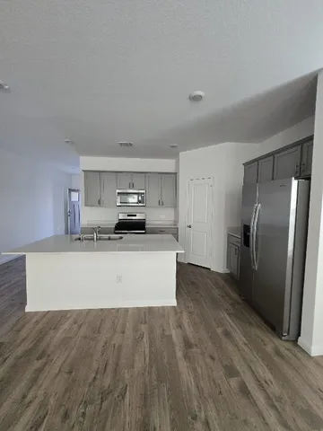 a view of empty room with wooden floor
