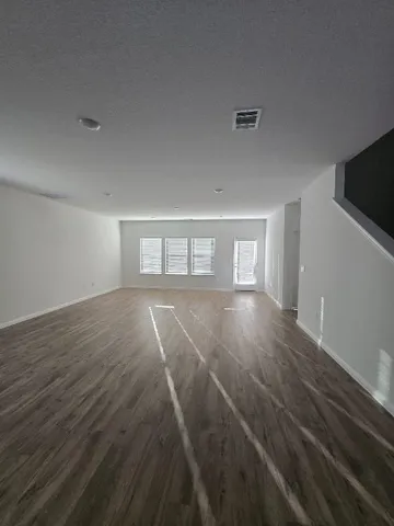 a living room with stainless steel appliances kitchen island a stove a refrigerator a sink a stove a microwave and cabinets