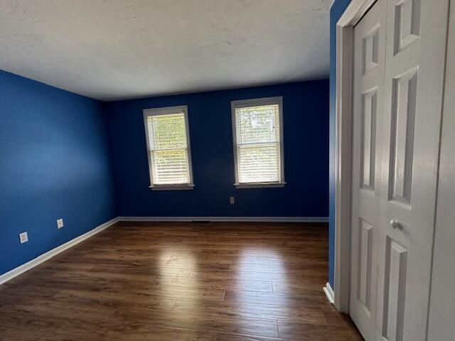 709 Old Barnstable Road Mashpee, MA 02649 - Photo 11 of 32 a view of an empty room with wooden floor and a window