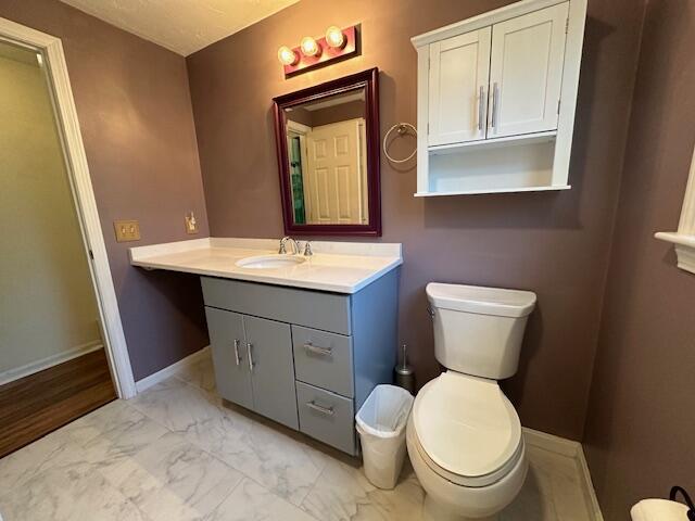 709 Old Barnstable Road Mashpee, MA 02649 - Photo 13 of 32 a bathroom with a toilet sink and mirror