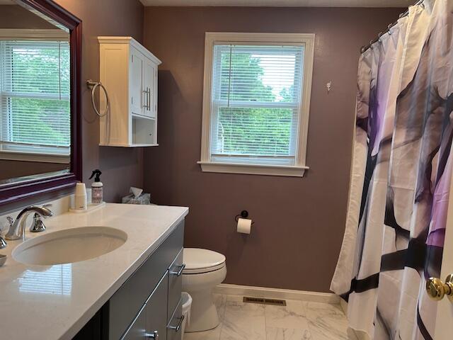 709 Old Barnstable Road Mashpee, MA 02649 - Photo 14 of 32 a bathroom with a sink toilet and a mirror