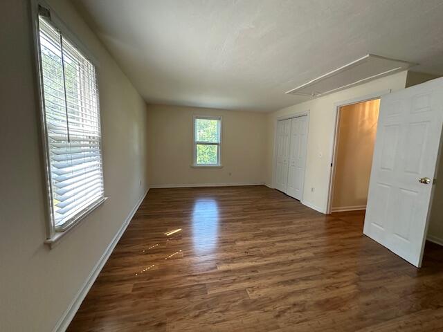709 Old Barnstable Road Mashpee, MA 02649 - Photo 18 of 32 a view of an empty room with wooden floor and a window