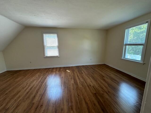 709 Old Barnstable Road Mashpee, MA 02649 - Photo 19 of 32 an empty room with wooden floor and windows