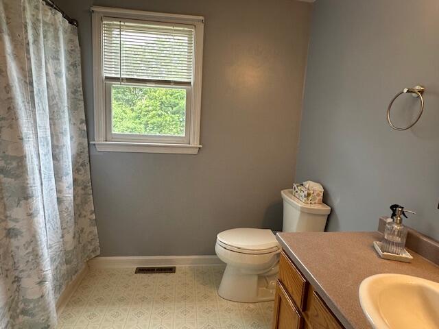 709 Old Barnstable Road Mashpee, MA 02649 - Photo 21 of 32 a bathroom with a granite countertop toilet and a sink