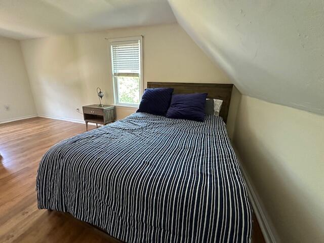 709 Old Barnstable Road Mashpee, MA 02649 - Photo 23 of 32 a bedroom with a bed and wooden floor