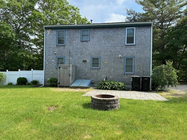 709 Old Barnstable Road Mashpee, MA 02649 - Photo 3 of 32 a backyard of a house with table and chairs