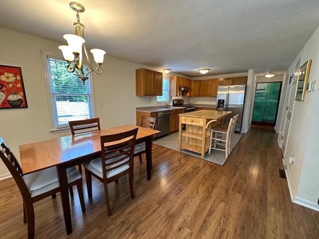 709 Old Barnstable Road Mashpee, MA 02649 - Photo 5 of 32 a view of a dining room with furniture window and wooden floor