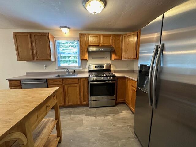 709 Old Barnstable Road Mashpee, MA 02649 - Photo 8 of 32 a kitchen with stainless steel appliances granite countertop a stove a sink and a refrigerator