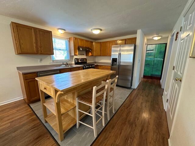 709 Old Barnstable Road Mashpee, MA 02649 - Photo 9 of 32 a kitchen with stainless steel appliances a table chairs refrigerator and microwave